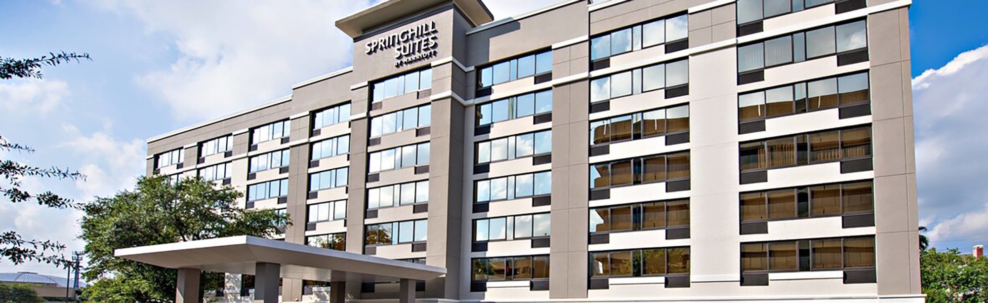 Grey Springhill Suites hotel with entrance overhang